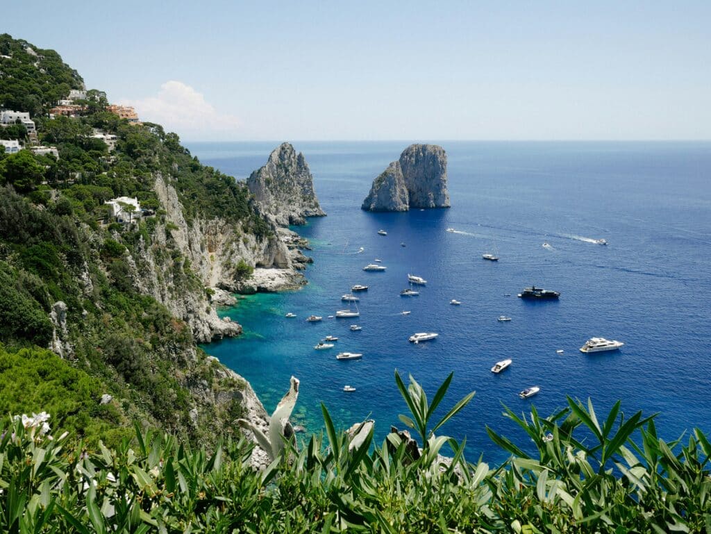 Faraglioni sea stacks off the coast of Capri island Campania Italy Trails
